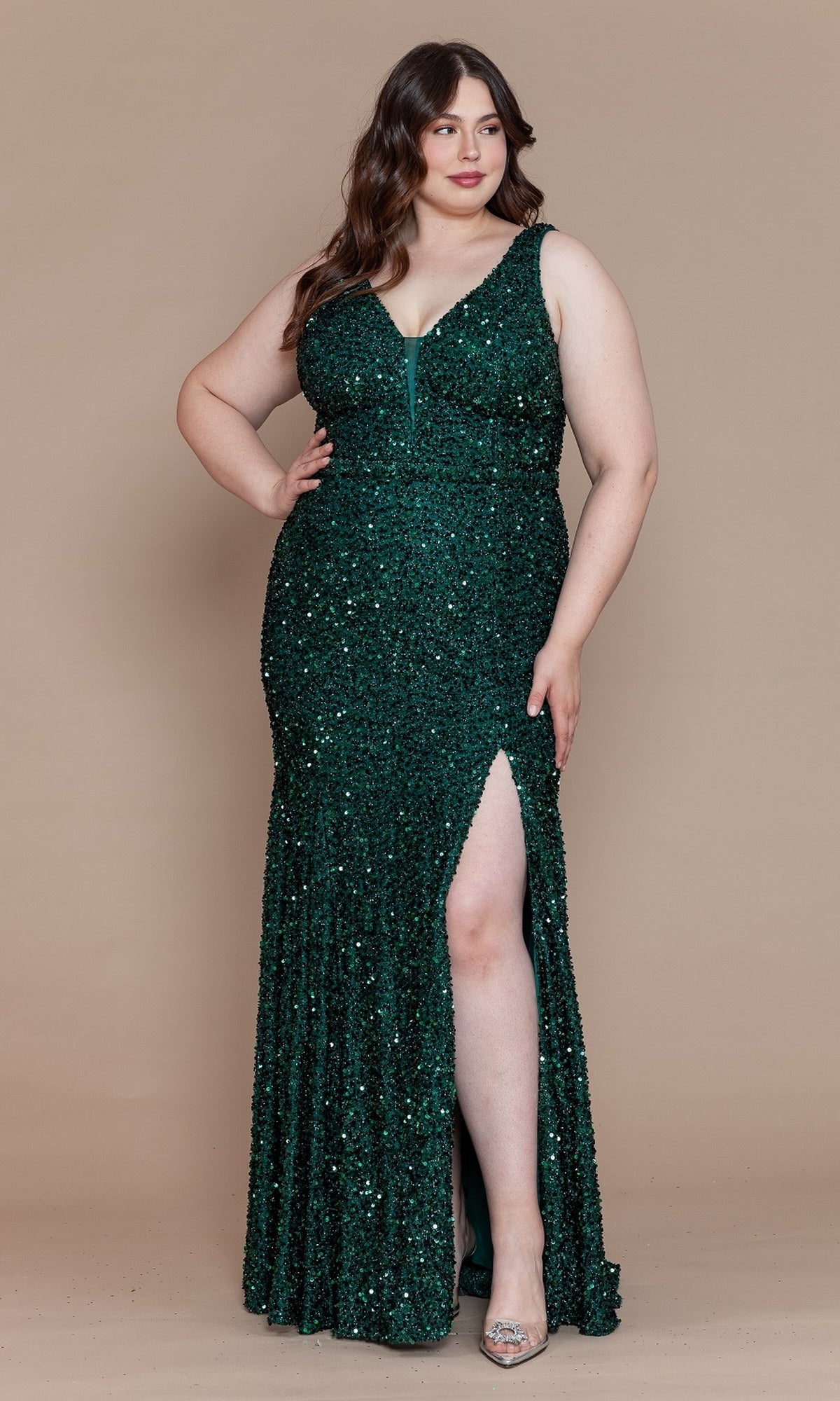 A woman models the Velvet-Sequin Plus-Size Long Prom Dress W1122—sleeveless, floor-length, dark green with a thigh-high slit—against a plain beige background.