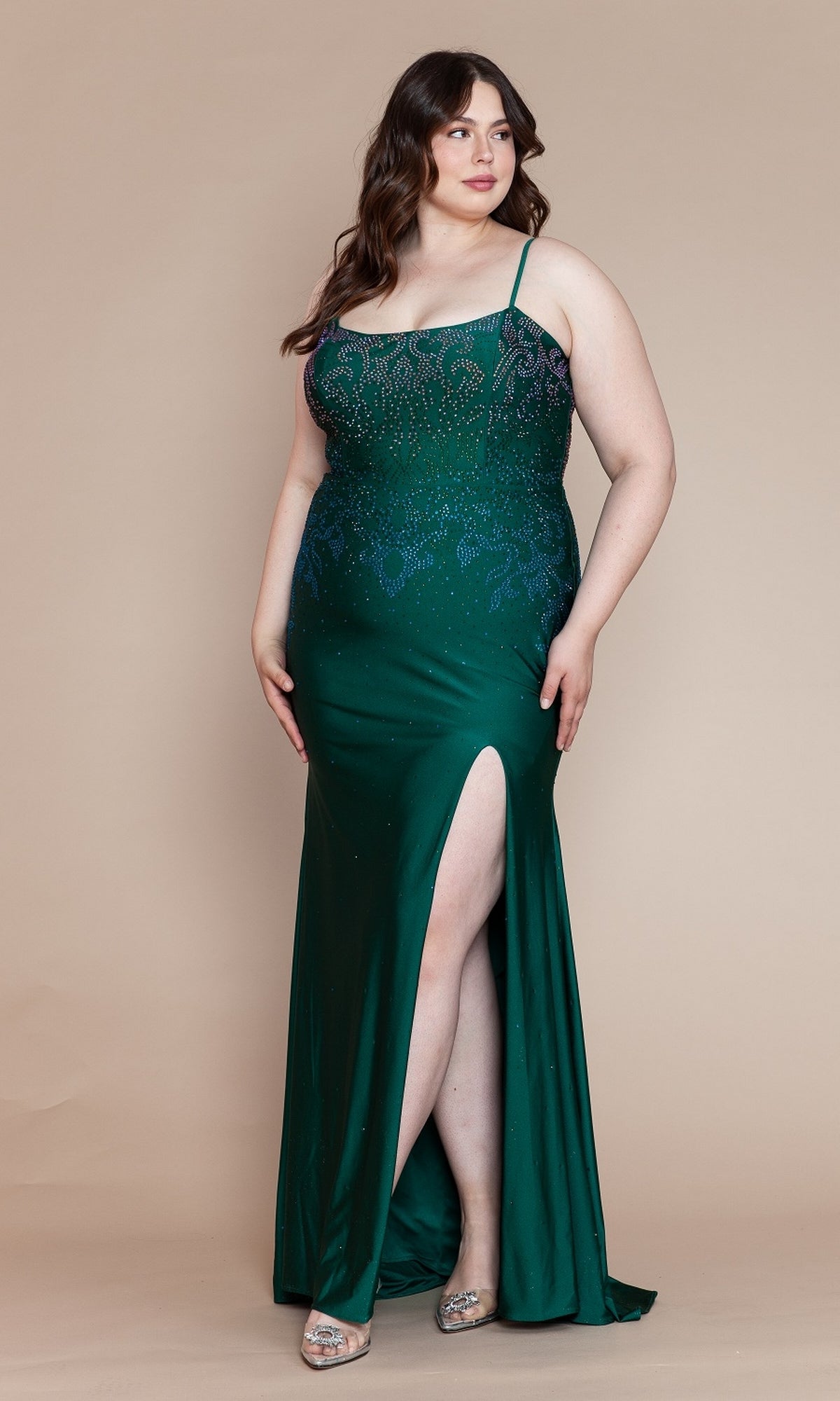 An elegant woman poses against a beige background in the Ombre-Beaded Plus-Size Long Prom Dress W1138 in emerald, featuring a sleeveless design, sparkling embellishments, and a thigh-high slit.