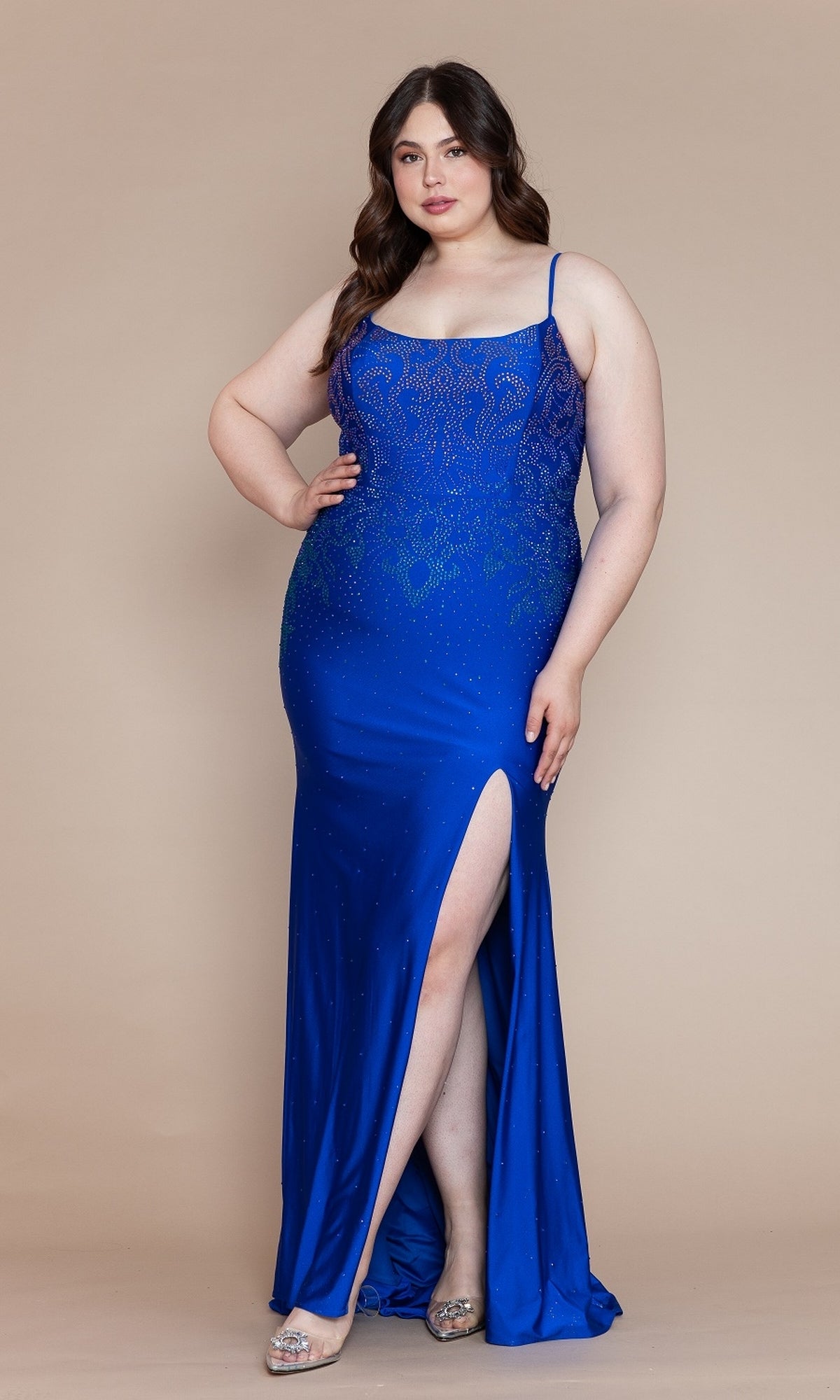 A woman poses in the Ombre-Beaded Plus-Size Long Prom Dress W1138, featuring intricate beadwork and a thigh-high slit, paired with silver high heels against a beige background.