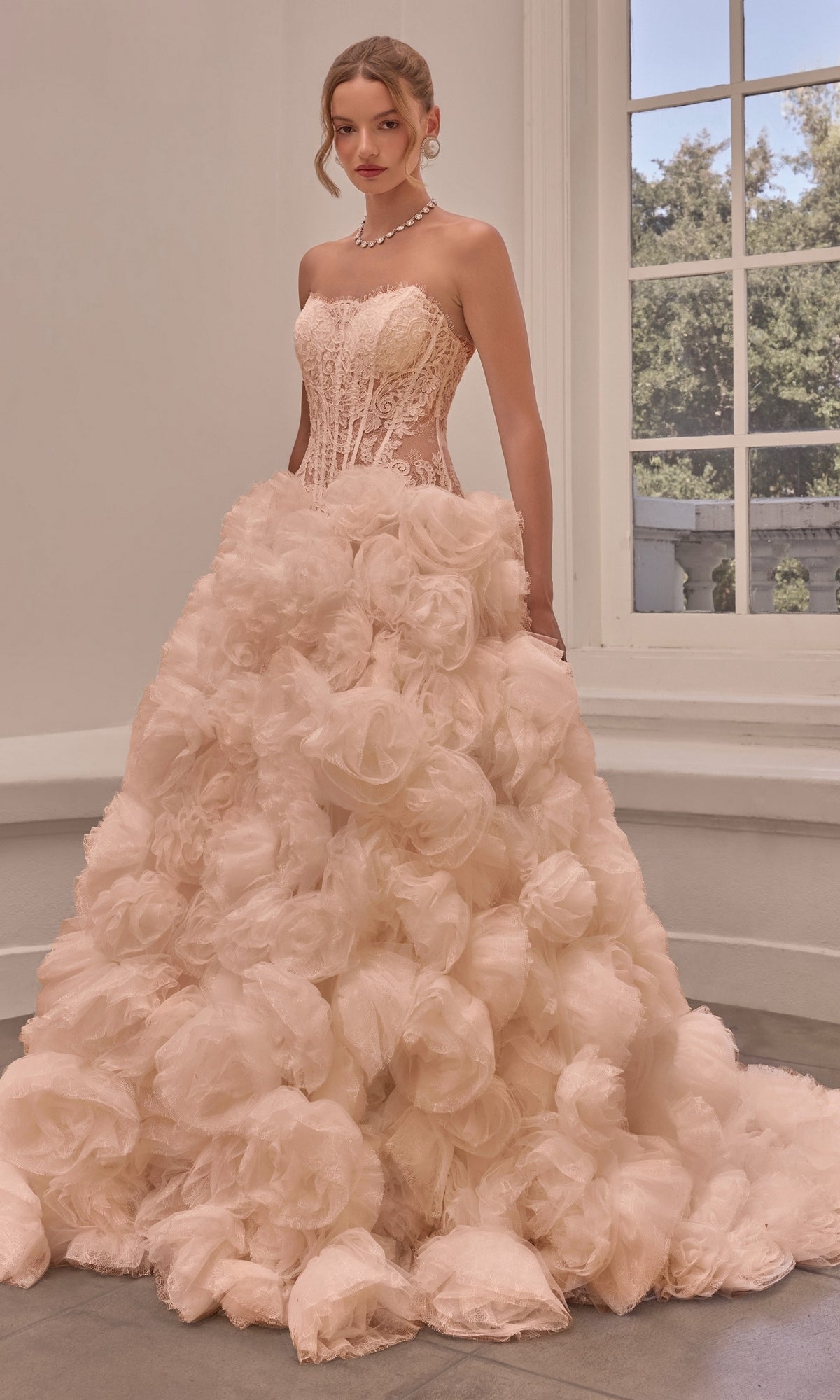 Strapless cream Andrea & Leo WL092 ball gown with a corset-style bodice and a voluminous skirt covered in large, 3D rosette floral appliqués.
