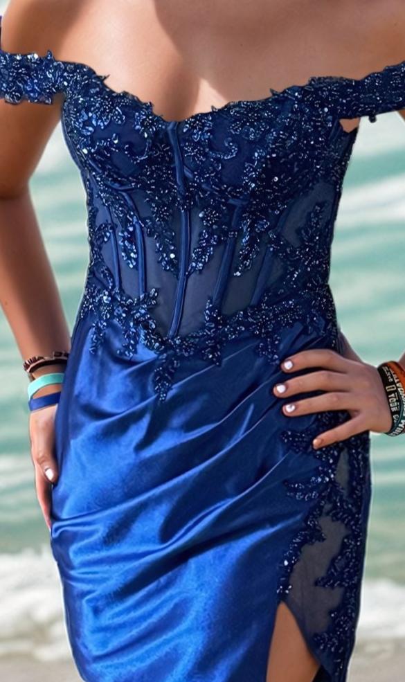 Wearing the PromGirl Royal Blue Beaded Homecoming Dress PD122S-R, featuring lace and sequin details, by the ocean.