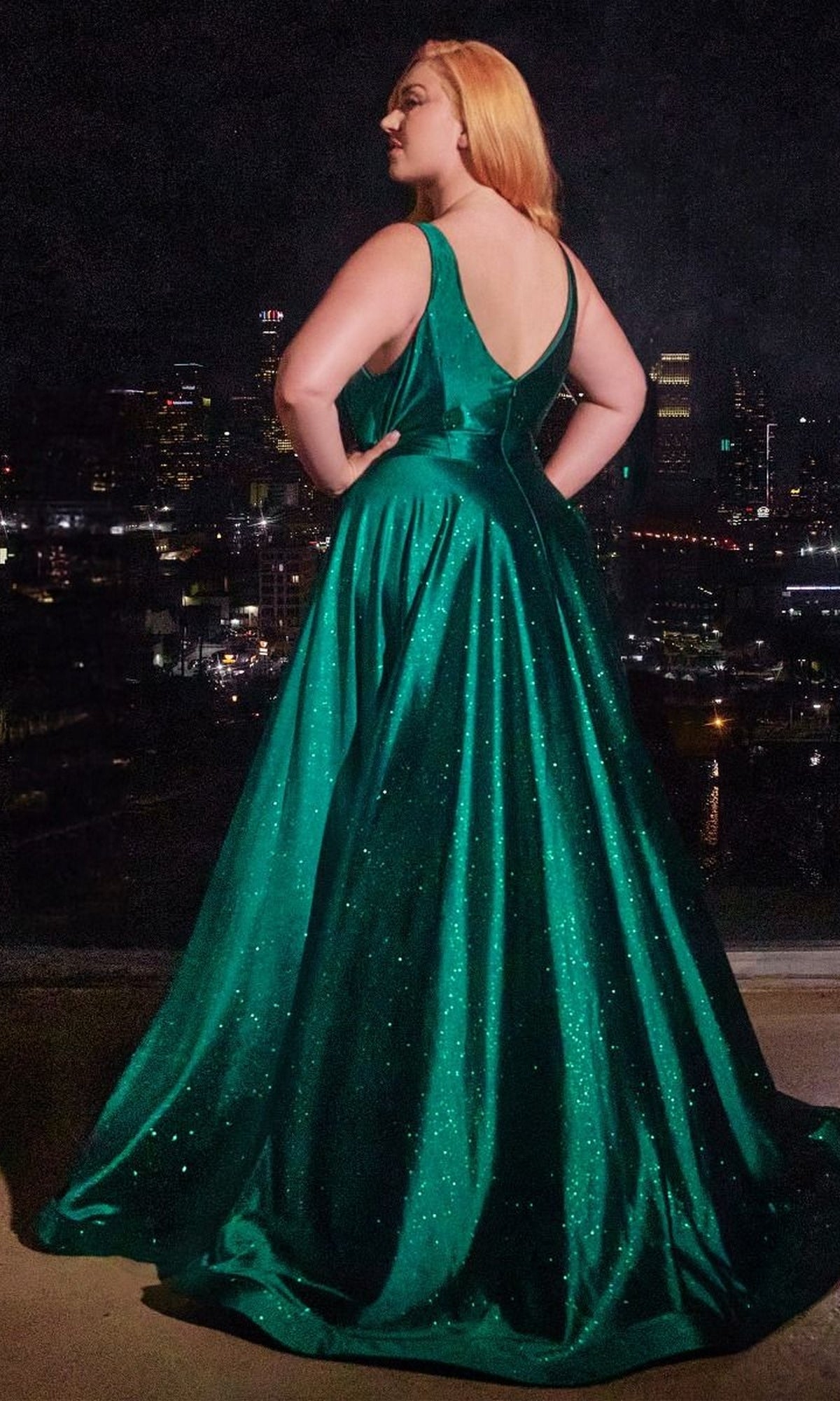 A woman in the Plus Long Glitter Prom Dress, Ladivine CC2349C, dazzles in a stunning green evening gown.