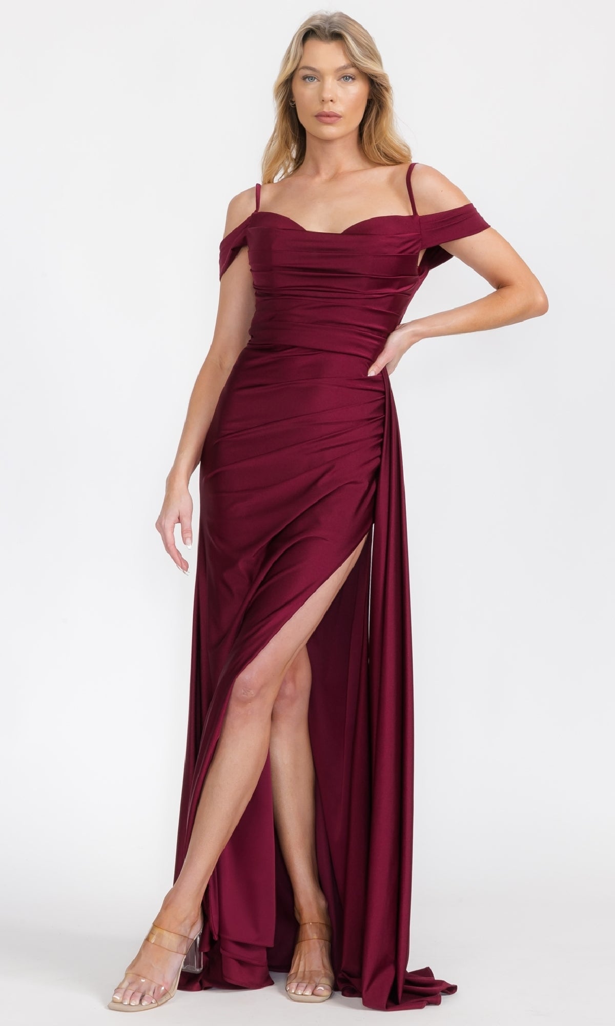 A woman models the Eureka EK117, an off-shoulder burgundy long formal dress with a thigh-high slit, against a white background—a stunning evening gown ideal for any special occasion.