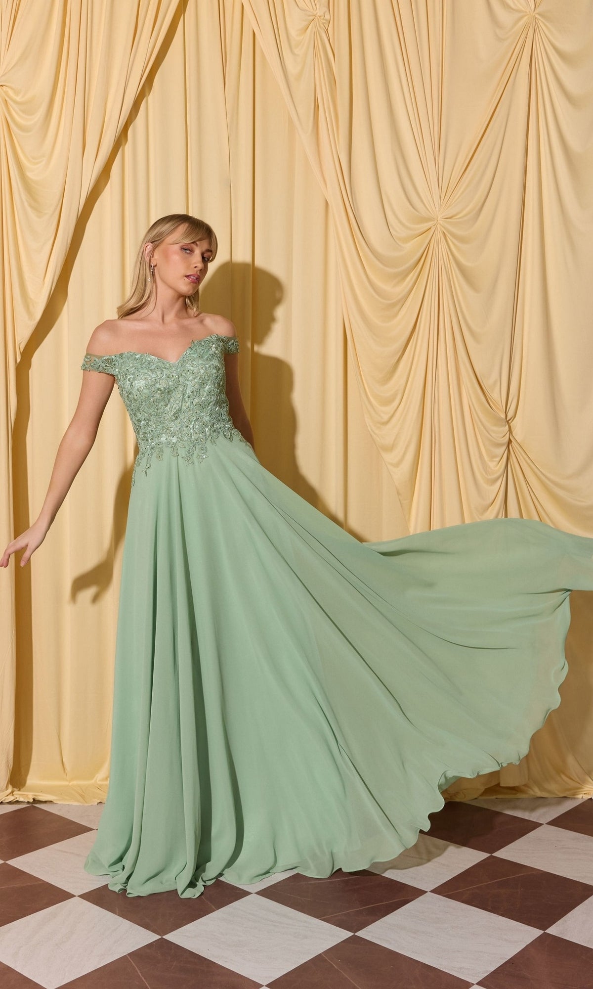 Woman in Long Prom Dress: Eureka EK211 with lace applique bodice and mint green skirt, posing before yellow drapes on a checkered floor.