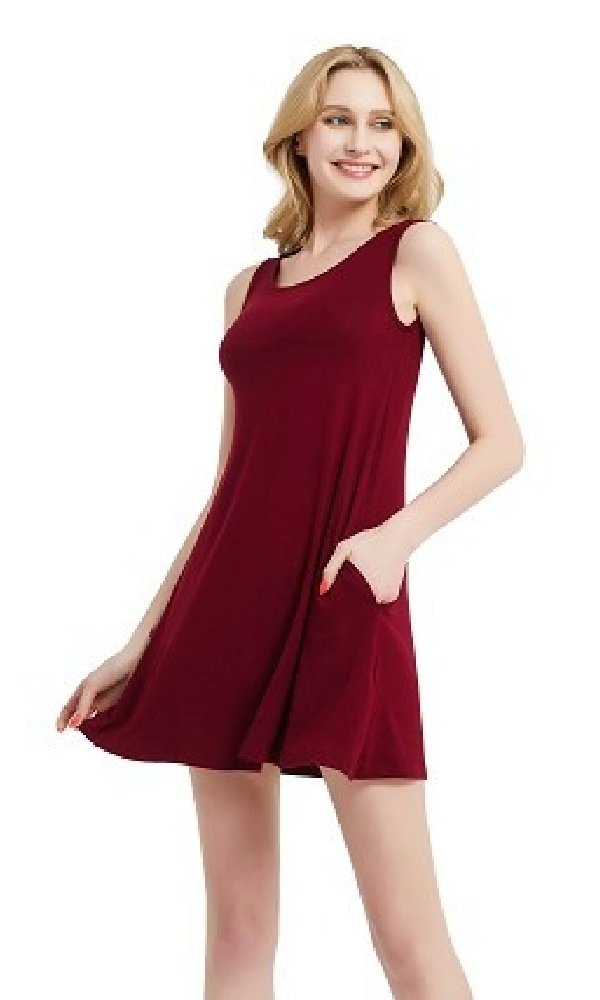 A woman stands smiling against a plain white background, wearing the Sleeveless Casual Short T-Shirt Dress with Pockets—a burgundy, sleeveless mini dress with an A-line silhouette and convenient side pockets.