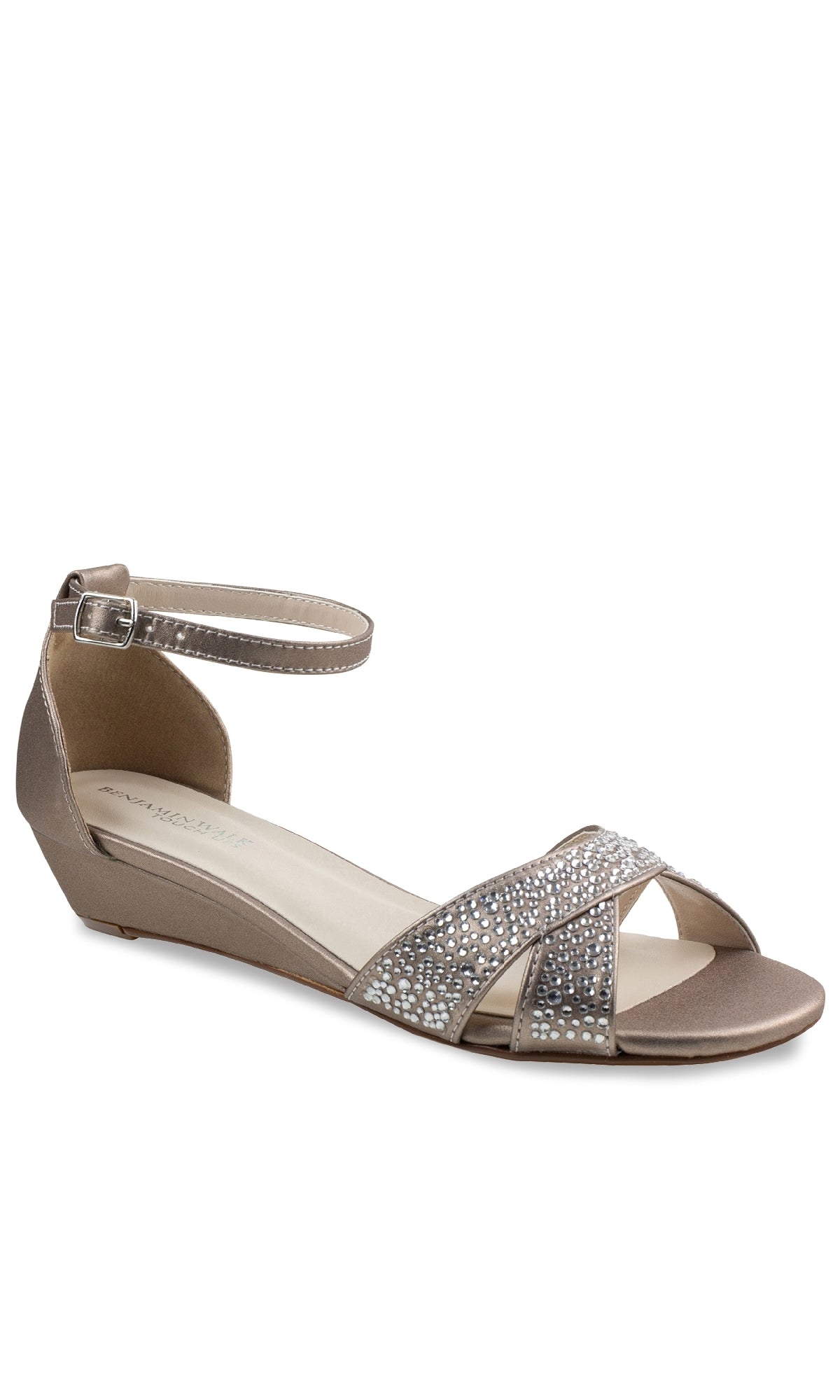 The Iris Champagne Wedge Prom Shoes (Touch Ups 4627) feature an open toe, low wedge heel, ankle strap, and crisscross beaded straps with silver rhinestones—making them a stylish choice for prom.