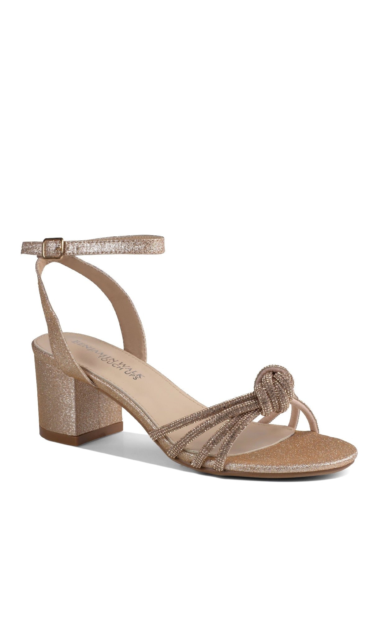 The Libra Champagne Glitter Prom Shoes: Touch Ups 4652 feature a gold glitter low block heel, ankle buckle strap, and knotted front detail—perfect for prom. Shown as a single shoe against a white background.