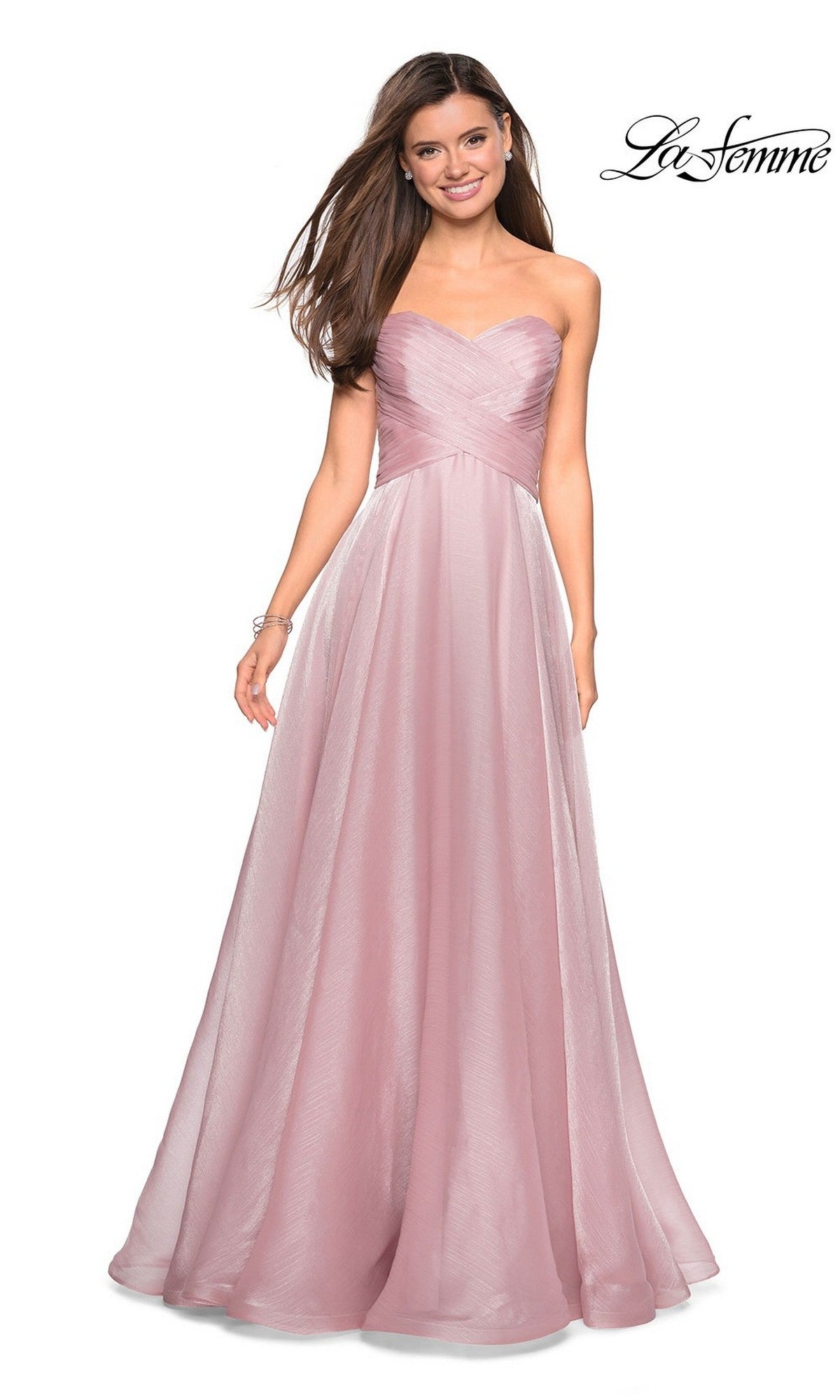 A woman stands smiling in the La Femme Strapless Long Prom Ball Gown 27515, a light mauve dress with a fitted sweetheart bodice and flowy A-line skirt. La Femme logo appears in the top right corner.