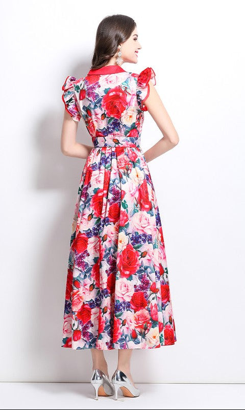 Model showing the back of a multi-color red floral maxi dress standing in front of white background.