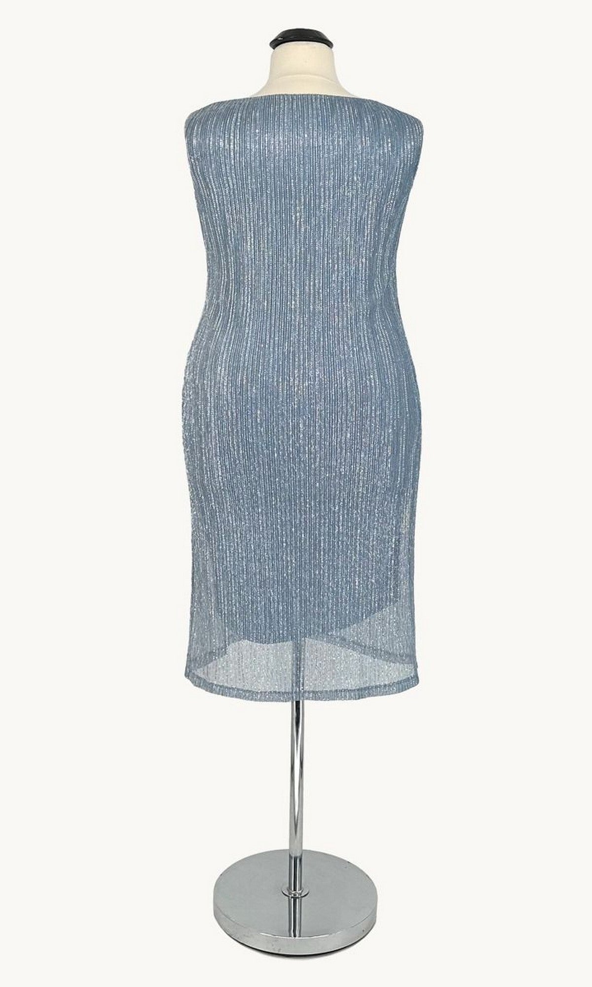 The Plus-Size Two-Piece Party Dress: Amoris T9001 is shown from the back on a mannequin, featuring a sleeveless silver-blue ribbed fabric and knee-length embellished design.