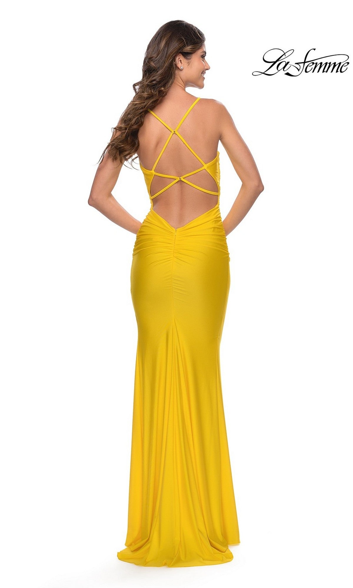 A woman poses against a white background wearing the La Femme Cowl-Neck Long Prom Dress 27501, featuring a bright yellow hue, fitted silhouette, and an open crisscross back.