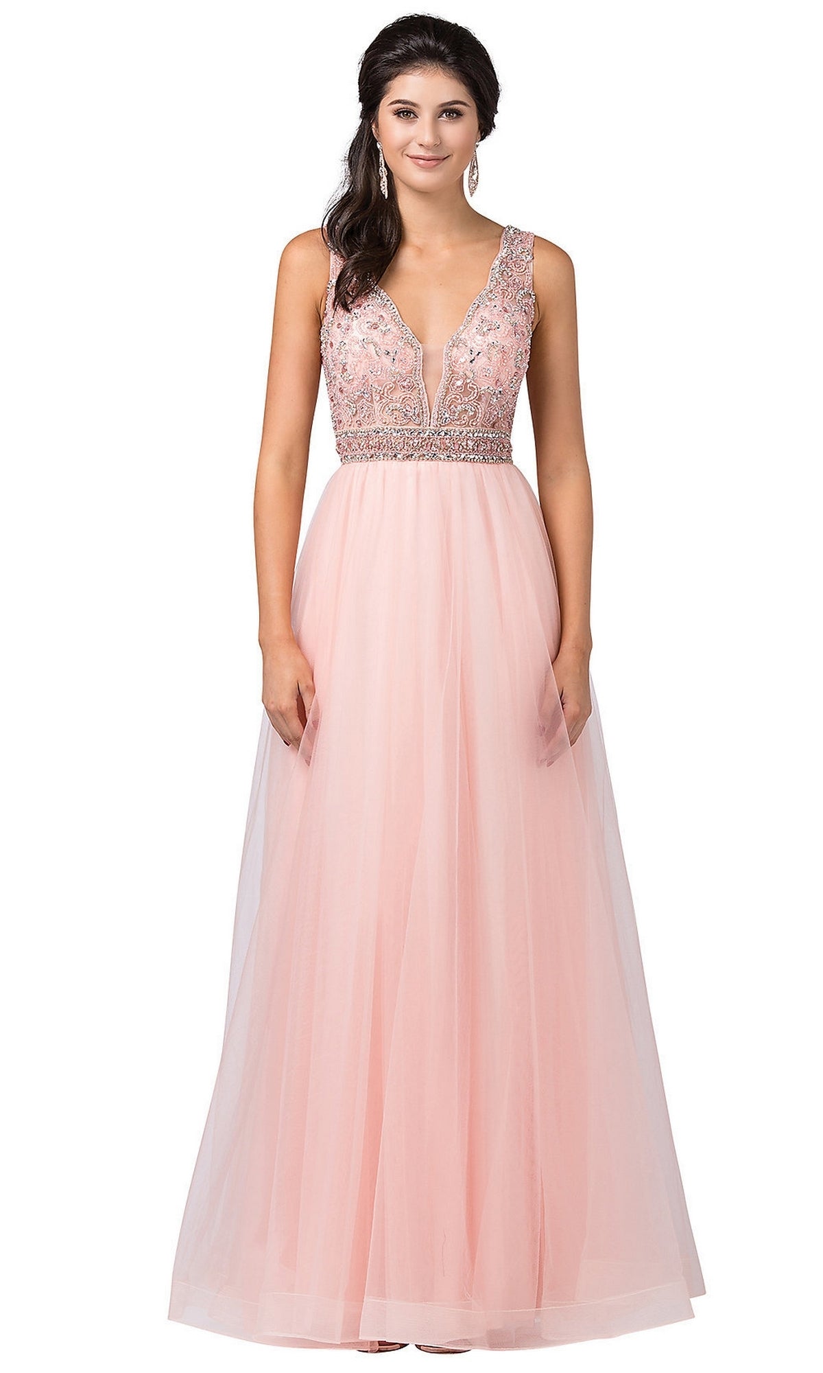 A woman is wearing the Beaded-Bodice Long Prom Ball Gown with Cut-Out, a sleeveless, floor-length blush pink dress featuring a beaded bodice and tulle skirt—ideal for anyone seeking an elegant formal look.