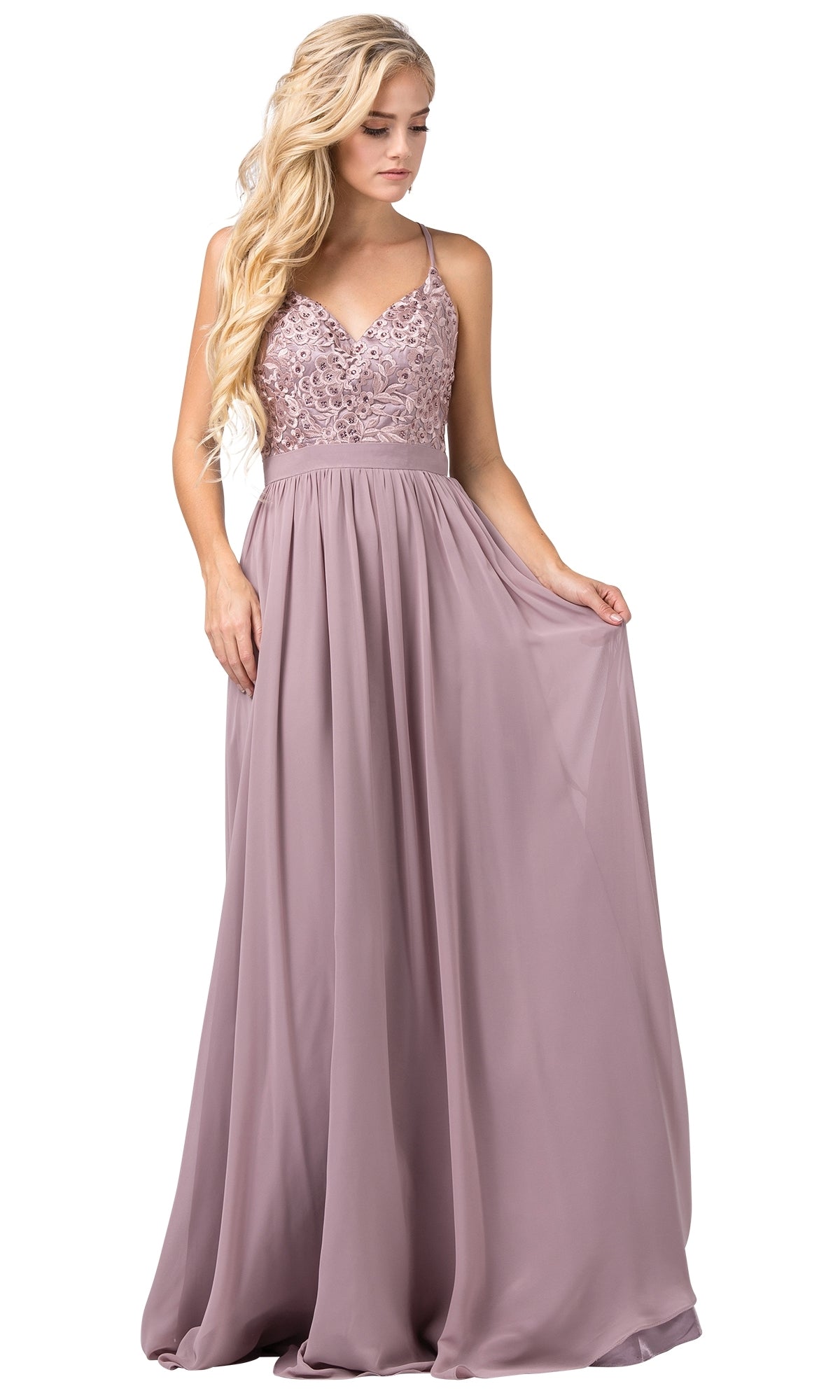 A woman wearing the Long Prom Dress with criss-cross back straps in mauve, featuring a floor-length skirt and lace bodice, holds out the skirt with one hand.