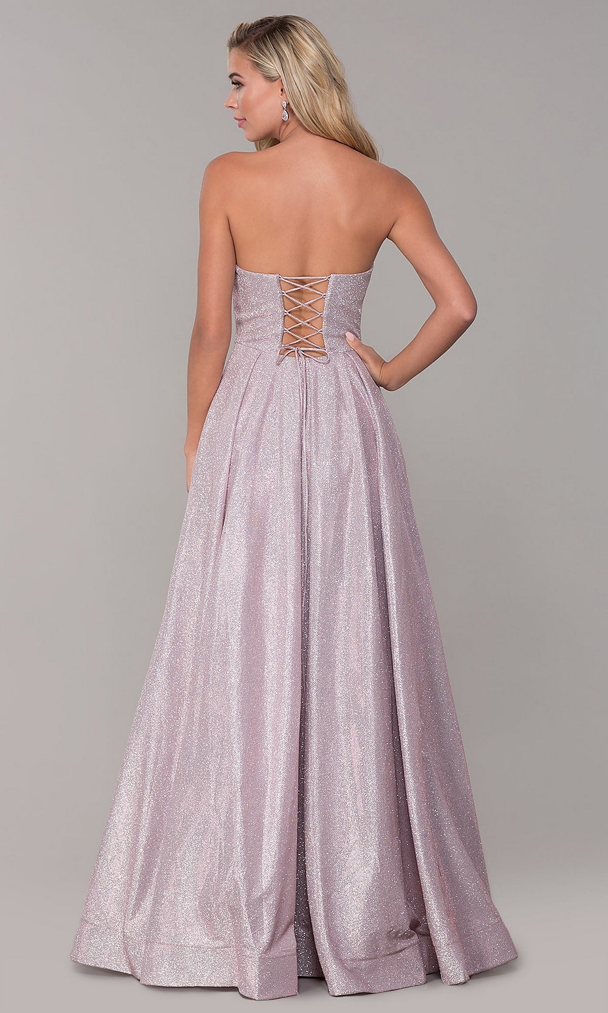A woman models the Long Strapless Glitter Prom Dress with Corset Back, a floor-length, glitter-satin evening gown, against a plain gray background.