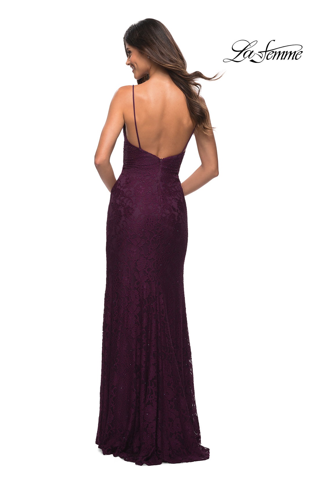 A woman faces away from the camera in a dark purple La Femme Tight Long Prom Dress in beaded lace, featuring thin straps, an open back, and a floor-length silhouette.