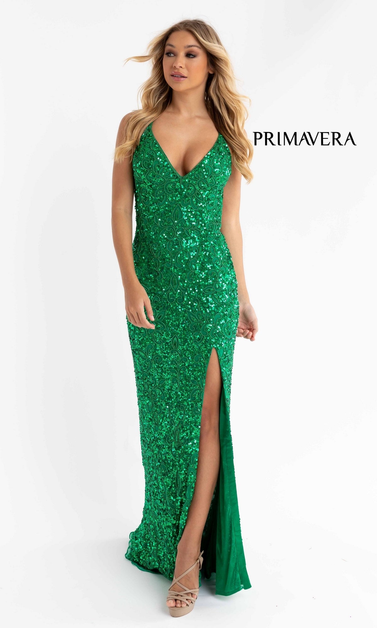 A woman poses against a plain white background in a sleeveless, green Bright Sequin-Pattern Long Prom Dress with a V-neckline and thigh-high slit.