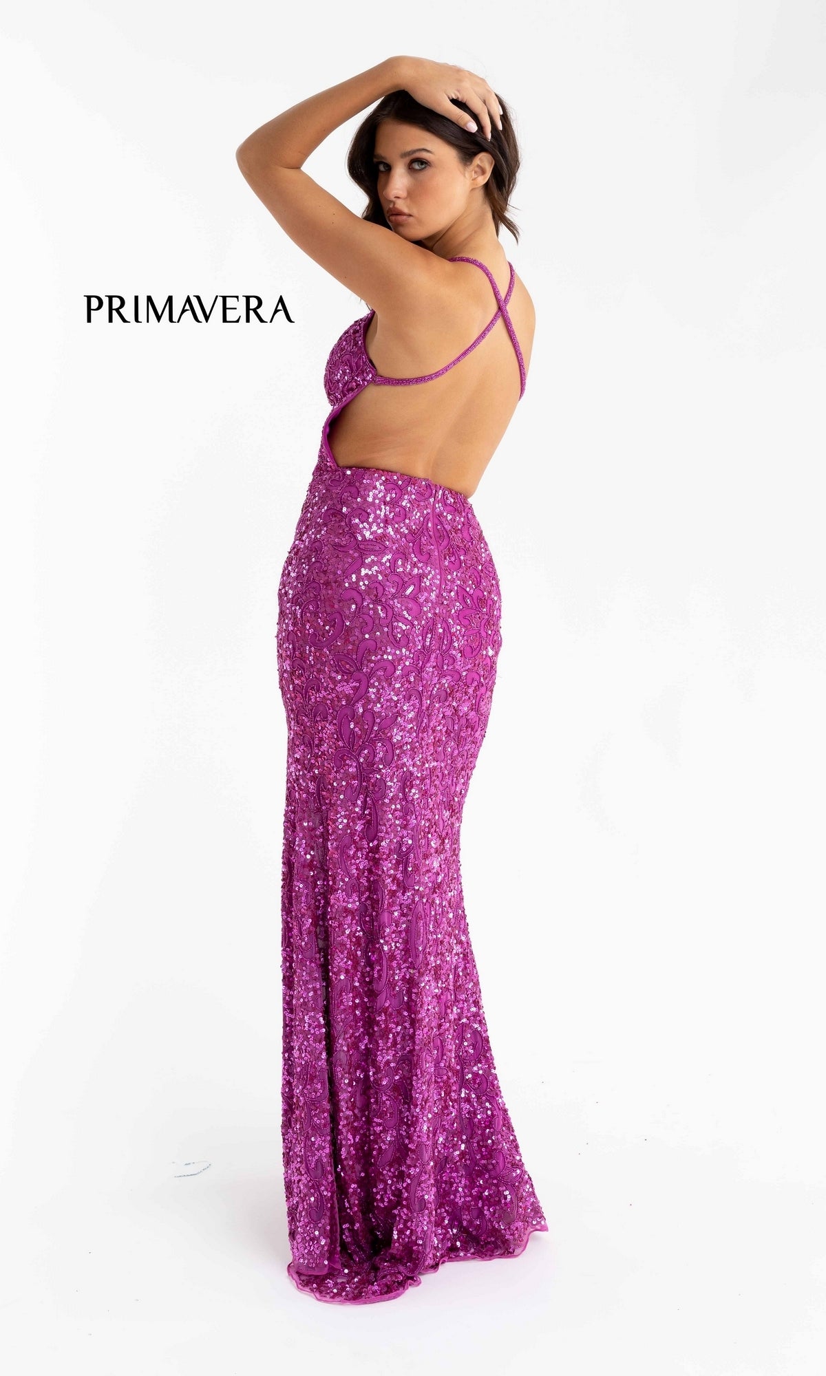 A woman poses in the Bright Sequin-Pattern Long Prom Dress, featuring a floor-length, backless design with crisscross straps, standing against a white background with