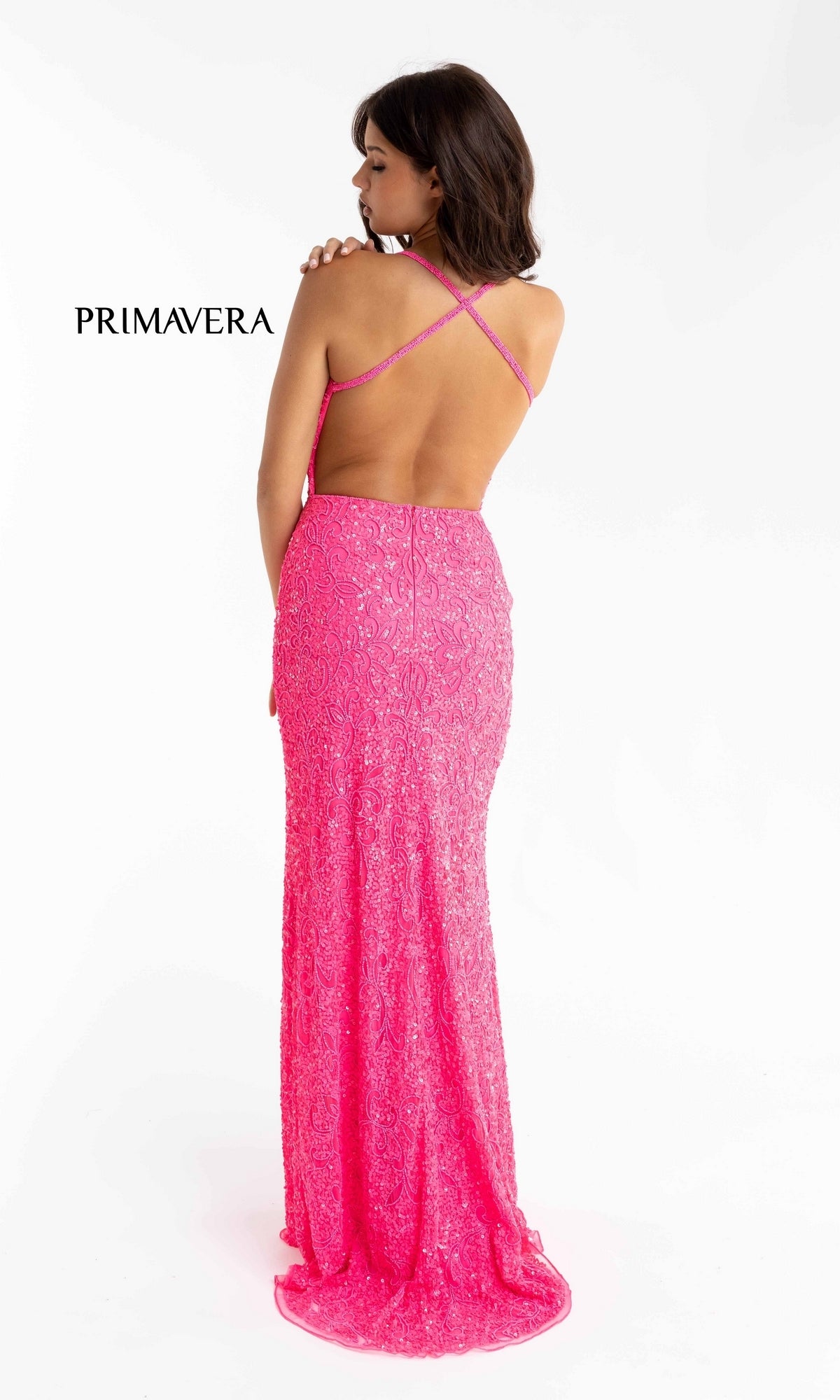 A woman faces away, modeling the Bright Sequin-Pattern Long Prom Dress—a vivid pink, floor-length gown with crossed back straps and lace details.