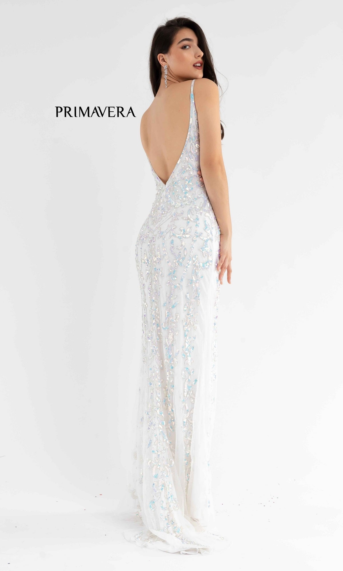 A woman models the Open-Back Primavera 3749 Long Sequin Prom Dress, showcasing its sleeveless, floor-length design and open-back detail.