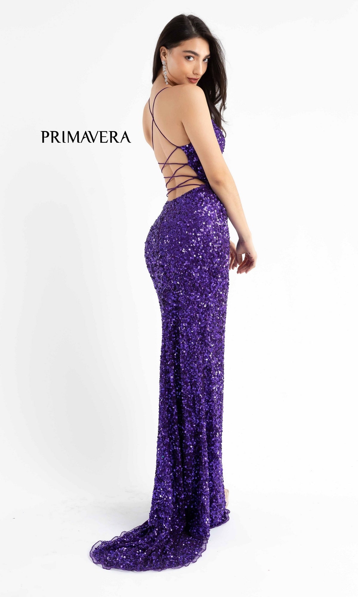 Woman in a floor-length Dark Long Sequin Prom Dress with strappy back (Style: 3791D) stands looking over her shoulder against a plain white background.