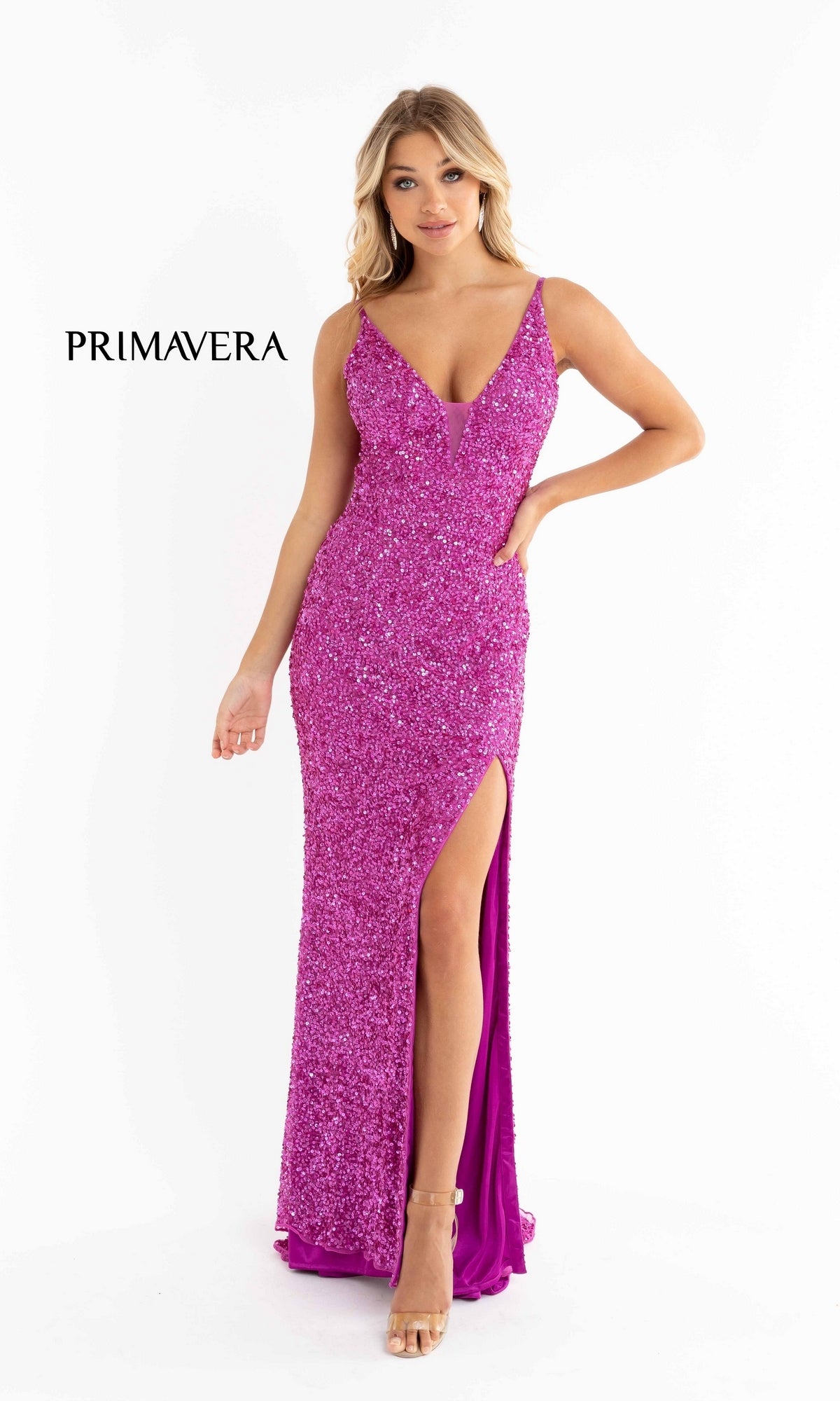 A woman wearing the Bright Sequin-Print Long Prom Dress 3792B, a sleeveless pink gown with a thigh-high slit, stands against a white background with