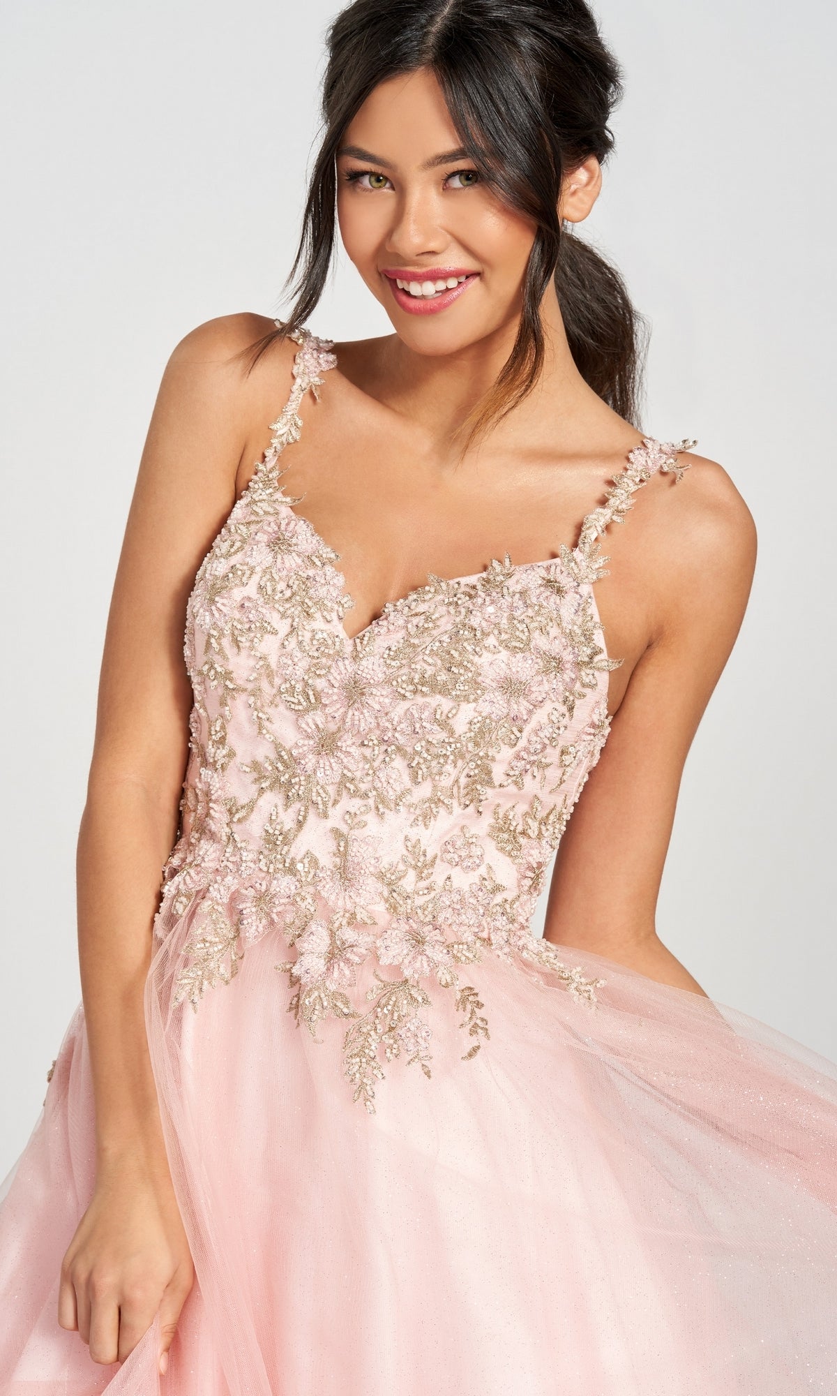 A woman in a Glitter Tulle Prom Dress with a beaded lace bodice and floral embroidery smiles at the camera.