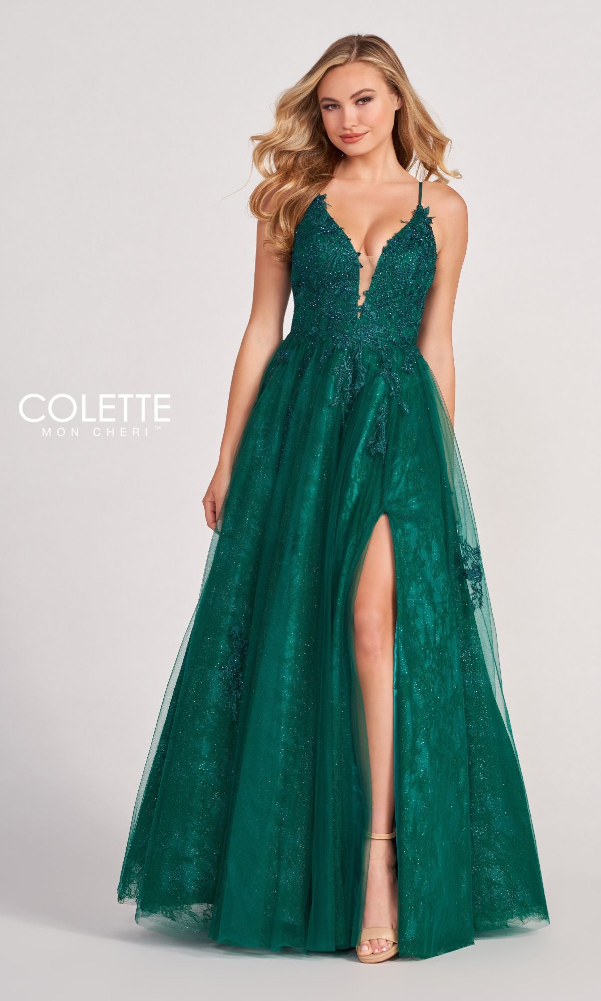 A woman models the Beaded Lace Long A-Line Prom Dress Colette CL2025, a deep green sleeveless gown with a plunging neckline, beaded lace accents, and a high slit, standing against a plain background.