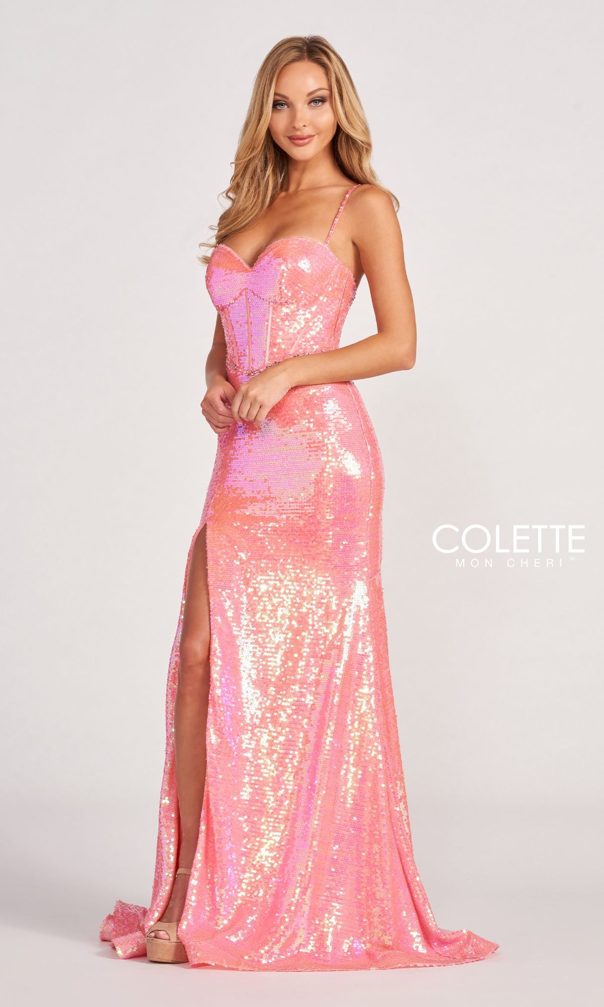 A woman wearing the Stretch Allover Sequin Dress With Corset CL2054—a floor-length pink gown with a thigh-high slit, spaghetti straps, and corset bodice—poses against a plain background as the Colette Mon Cheri logo appears.