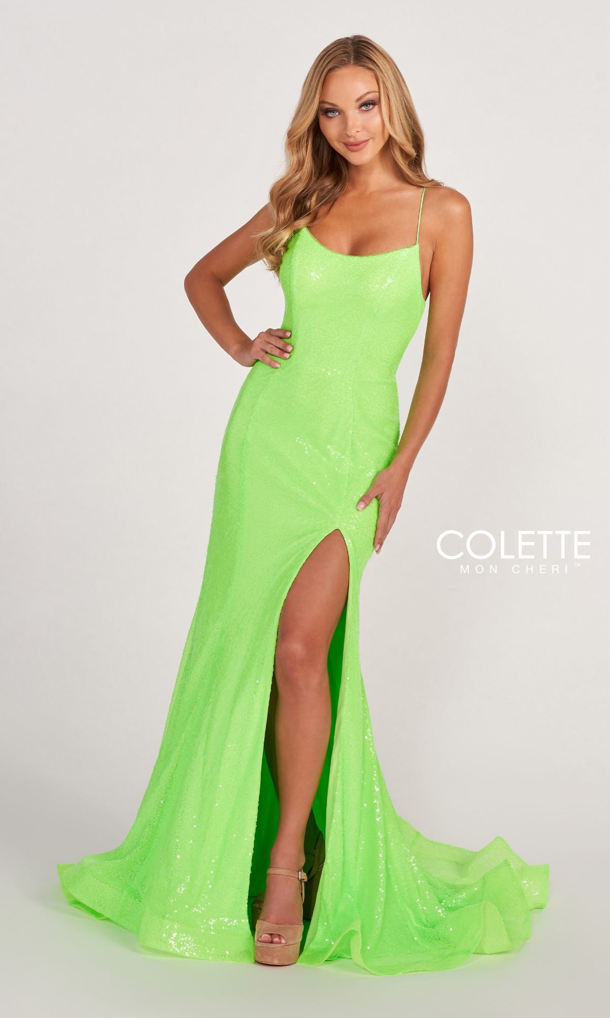 A woman poses in the Bright Neon Sequin Colette CL2060 Long Prom Dress, featuring thin straps, a high leg slit, and a corset back, standing against a plain light background.