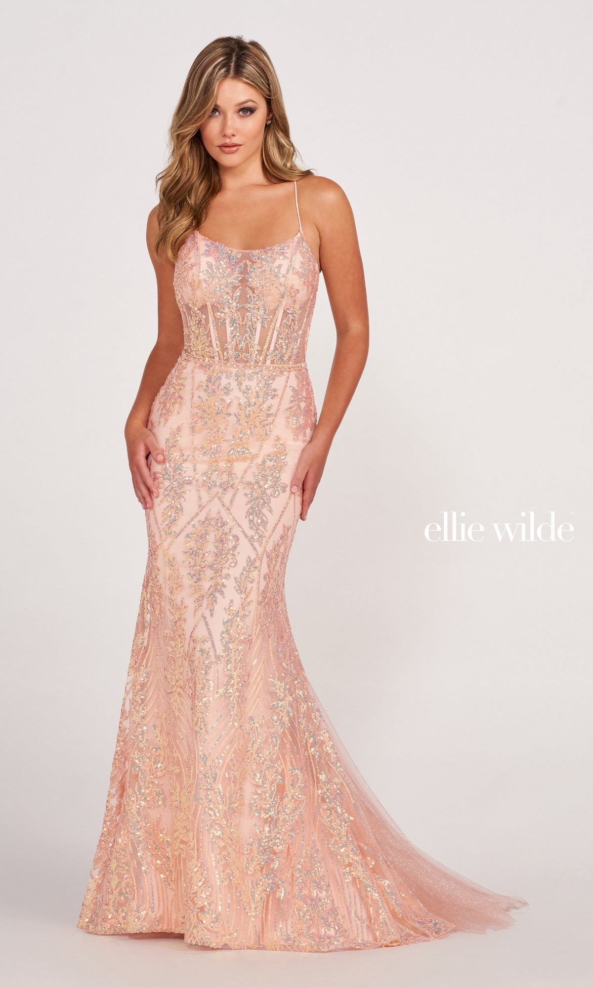 A woman in a fitted, floor-length pale pink Sheer-Corset Long Sequin Mermaid Prom Dress featuring intricate beading, thin straps, and an open back stands against a plain background. The text