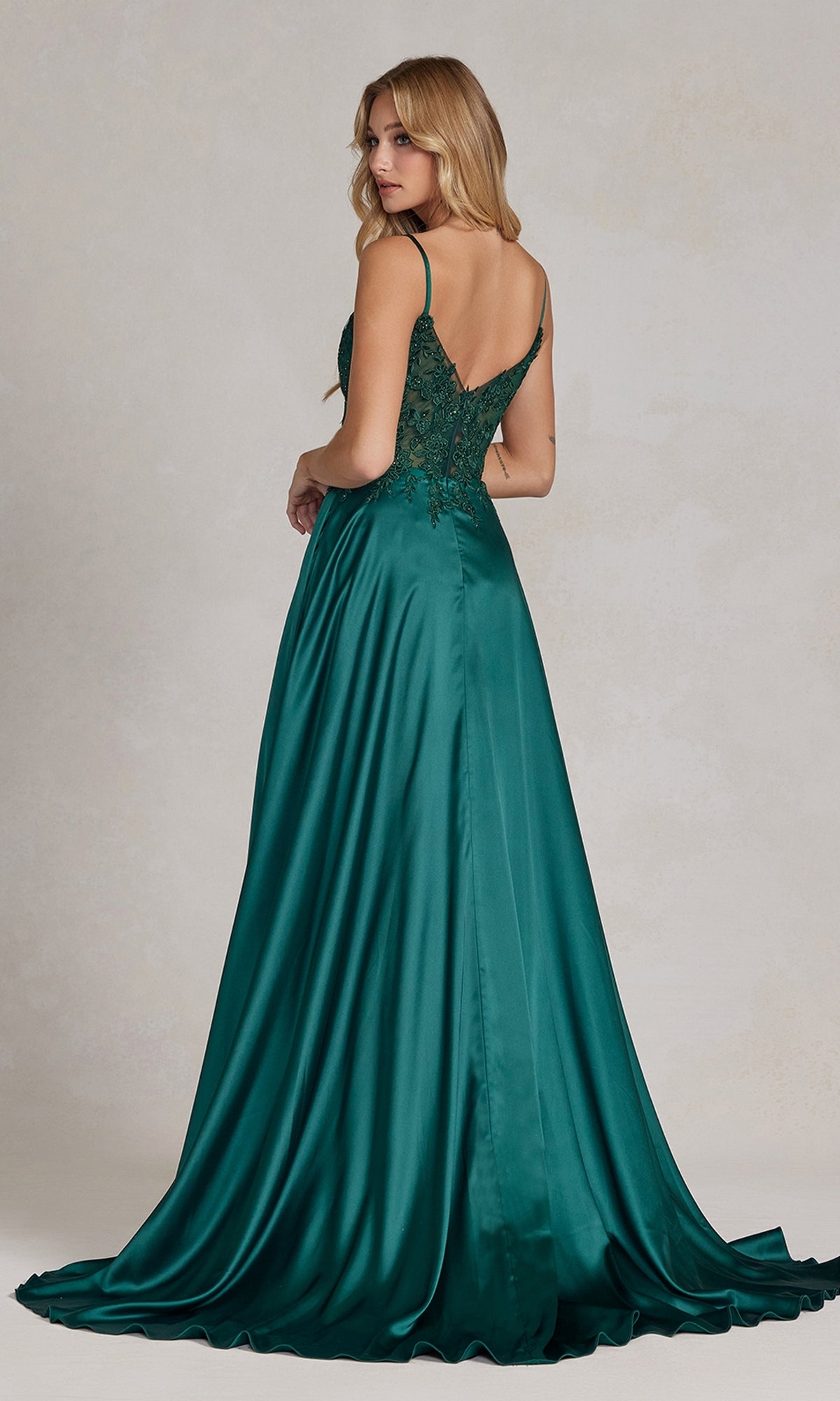 A woman, pictured from the back, wears a floor-length emerald green Faux-Wrap A-Line Long Prom Dress with a corset.