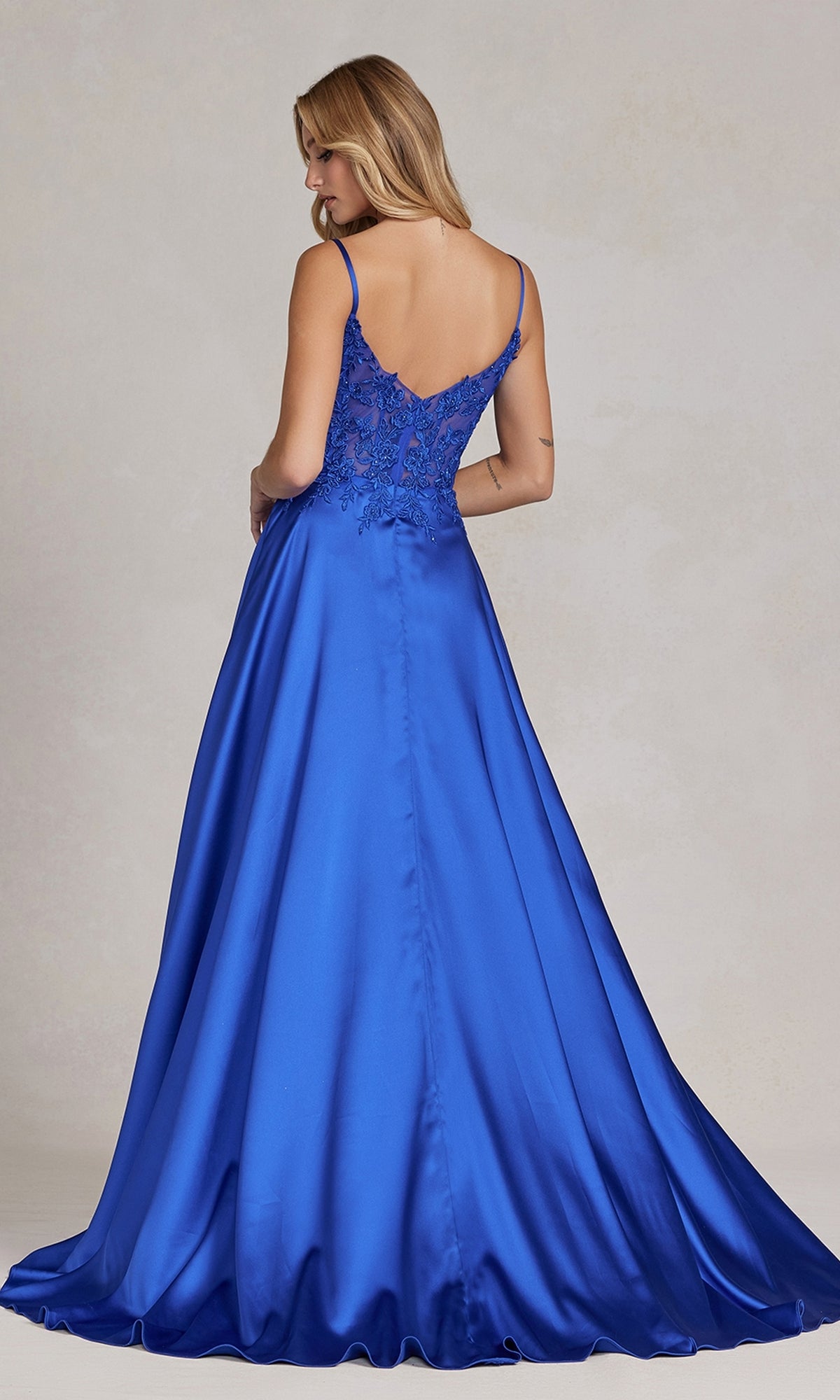 Woman shown from the back wearing a Faux-Wrap A-Line Long Prom Dress with corset, featuring thin straps and a beaded-lace bodice in royal blue satin.