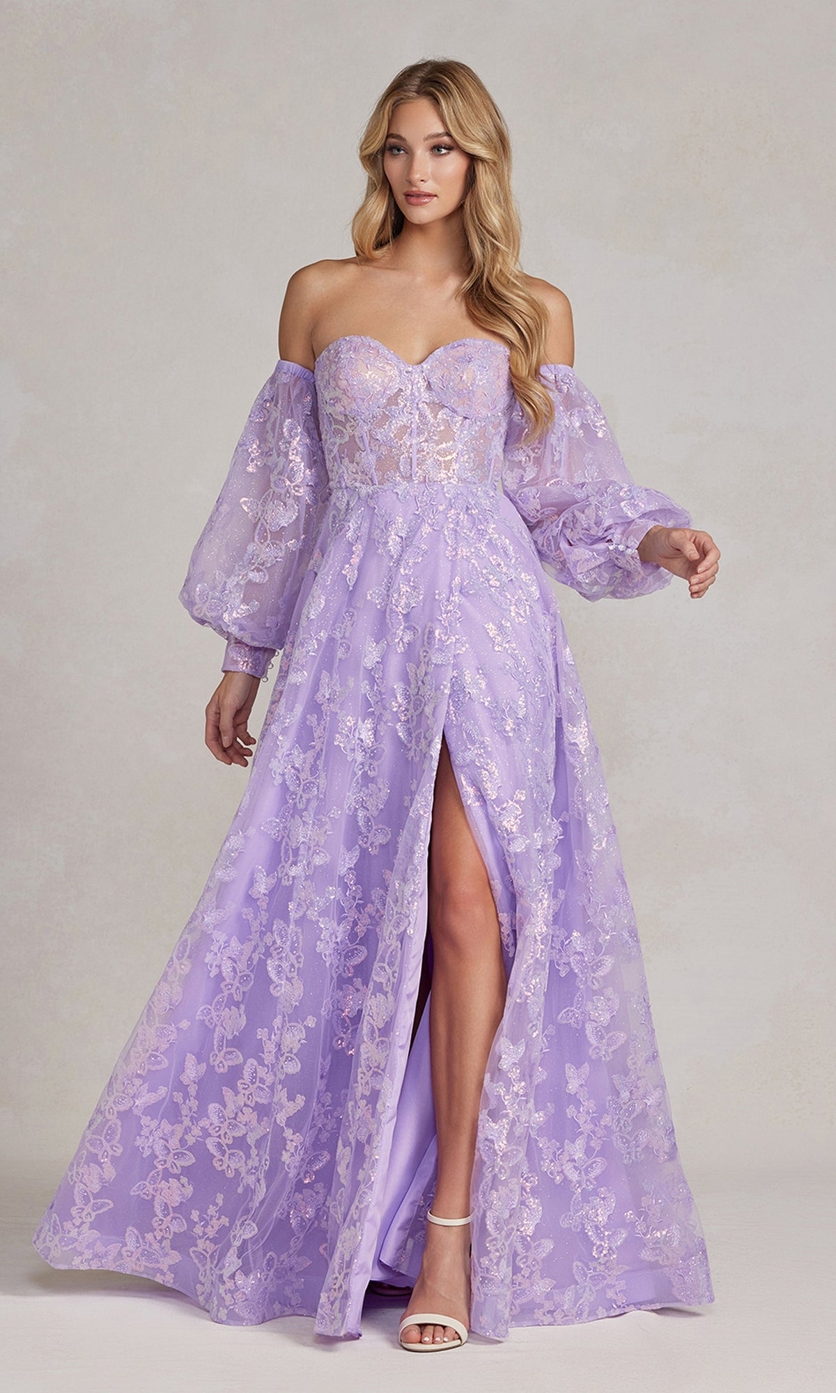 A woman models the Long Puff-Sleeve Prom Dress with a sheer bodice, removable long sleeves, floral lace details, and a front slit, standing against a neutral background.