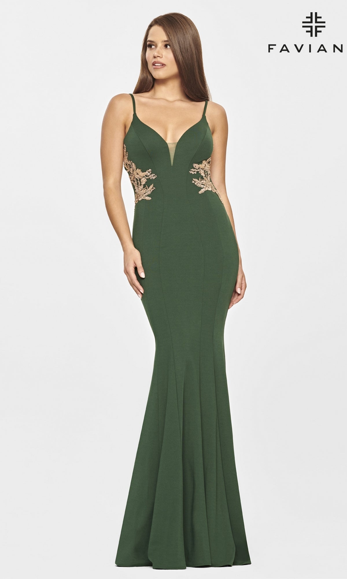 A woman wears the Faviana Long Navy Blue Prom Dress with gold beads, featuring thin straps, a plunging neckline, fitted mermaid silhouette, and elegant gold embroidery on the sides.