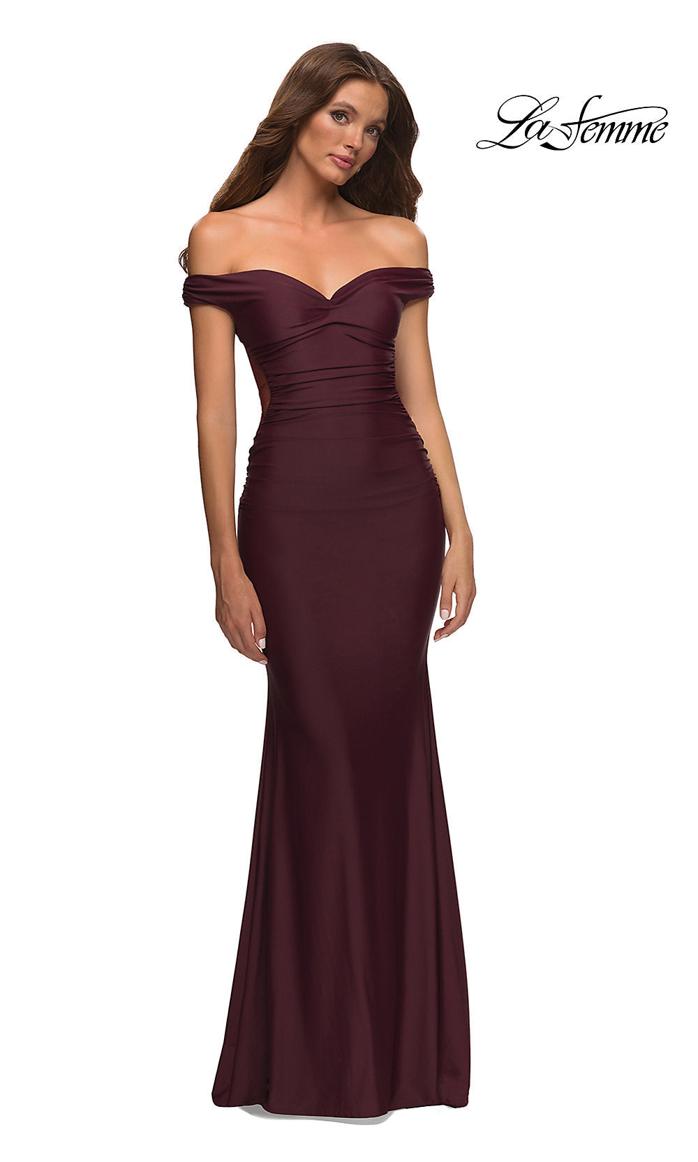 A woman in a La Femme Sheer-Back Off-Shoulder Long Prom Dress in dark wine stands against a white background.