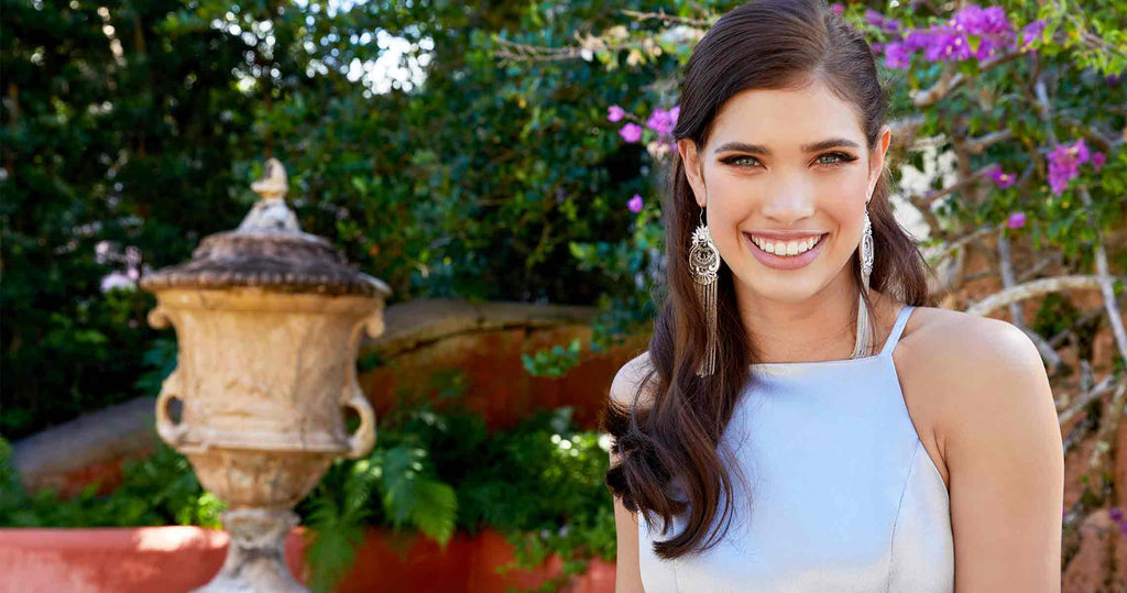 Smiling teen wearing a modest high-neck prom dress.