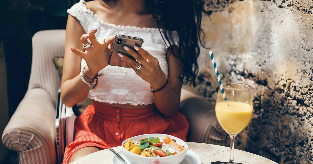 Close up of teen's hands using a phone to call dibs on her prom dress via social media.