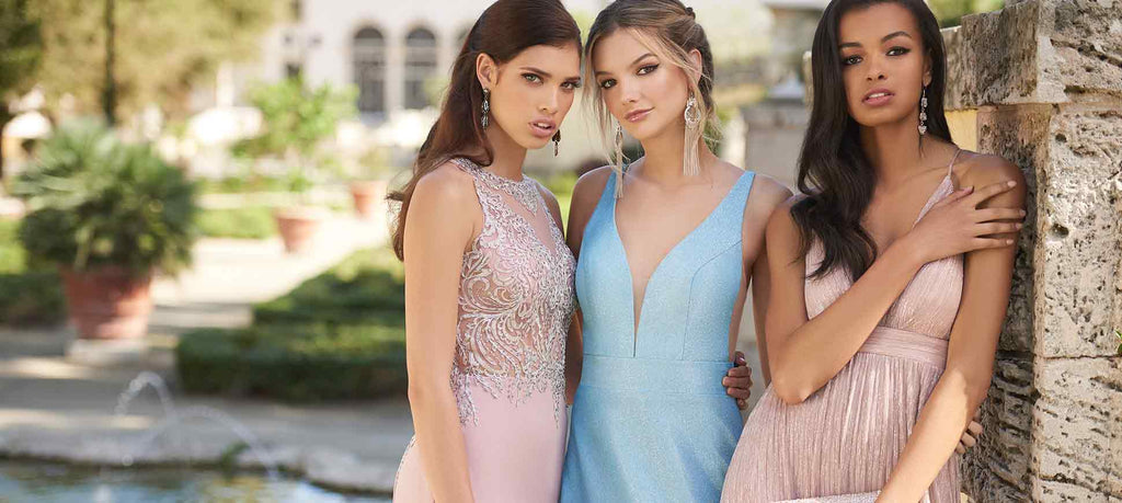Three teen girls in different prom dress styles against a faded garden backdrop.