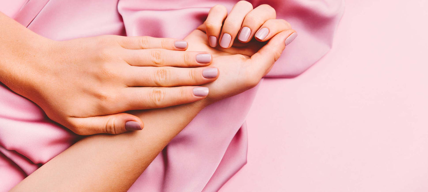 Close up of a pretty pink prom manicure.