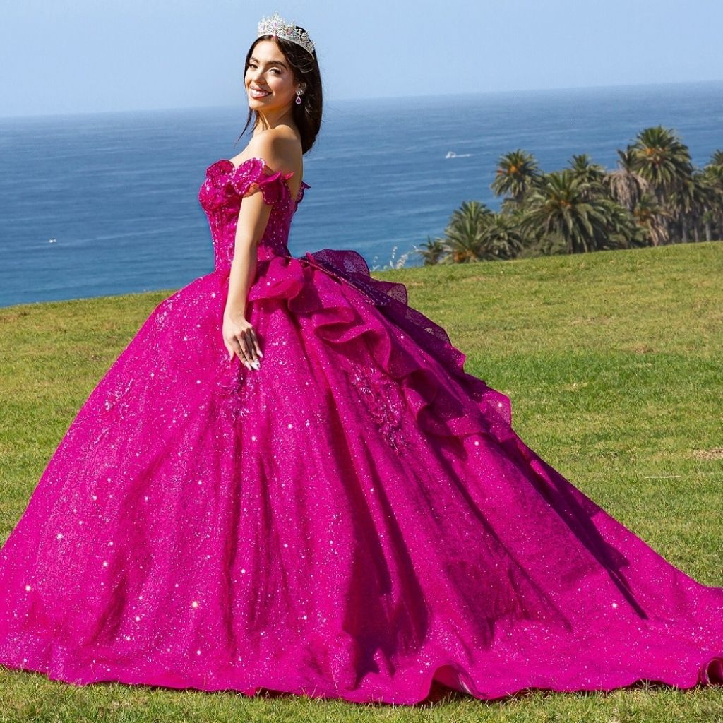 Side view of a teen girl wearing a fuchsia purple butterfly quinceanera dress by Cinderella Couture.