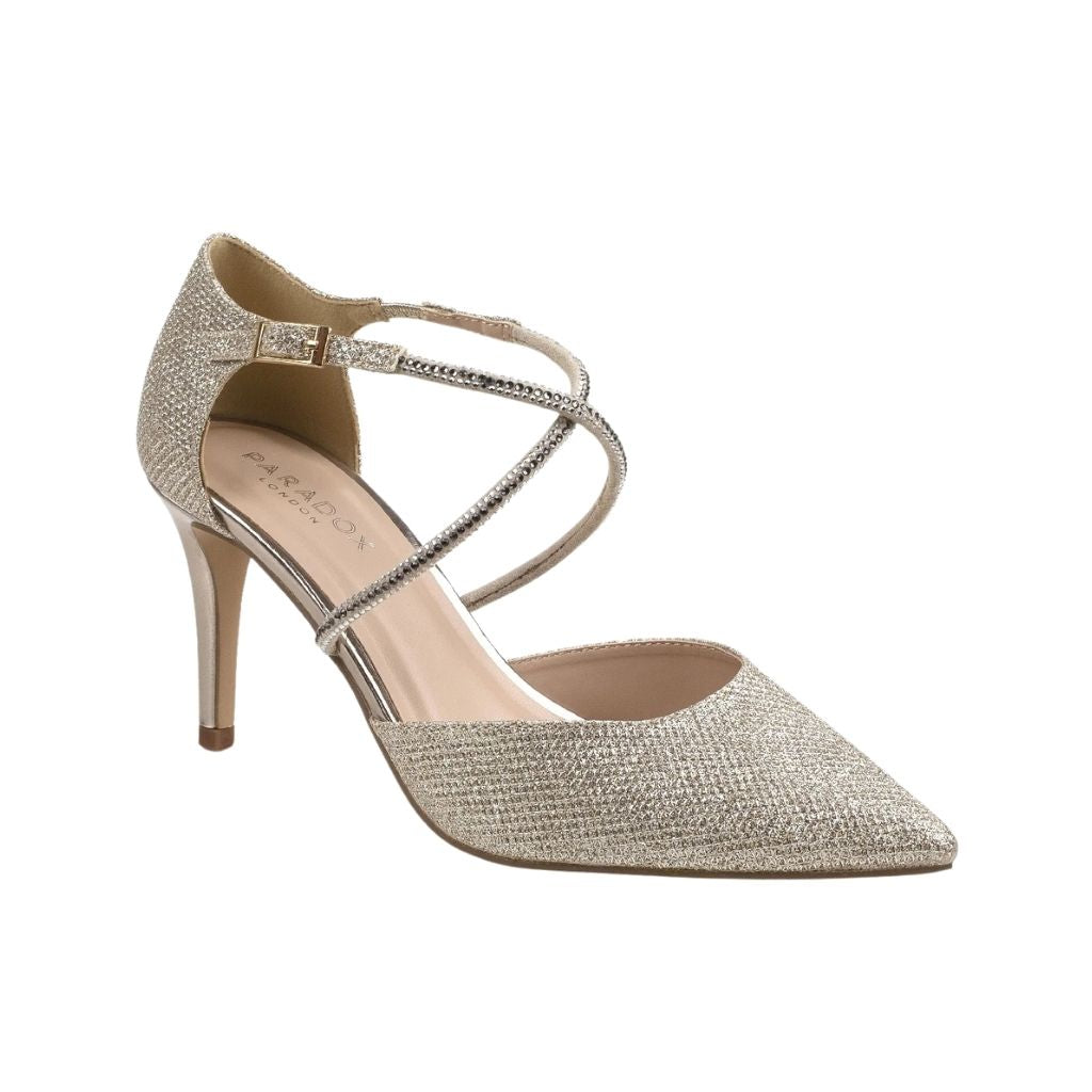Close up of closed-toe champagne shimmer prom shoes with high stiletto heels, crossing straps, and a buckle closure.