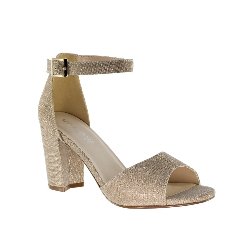 Close up of an open-toe champagne formal prom shoe with 2.5-inch block heels and an ankle strap with a buckle closure.