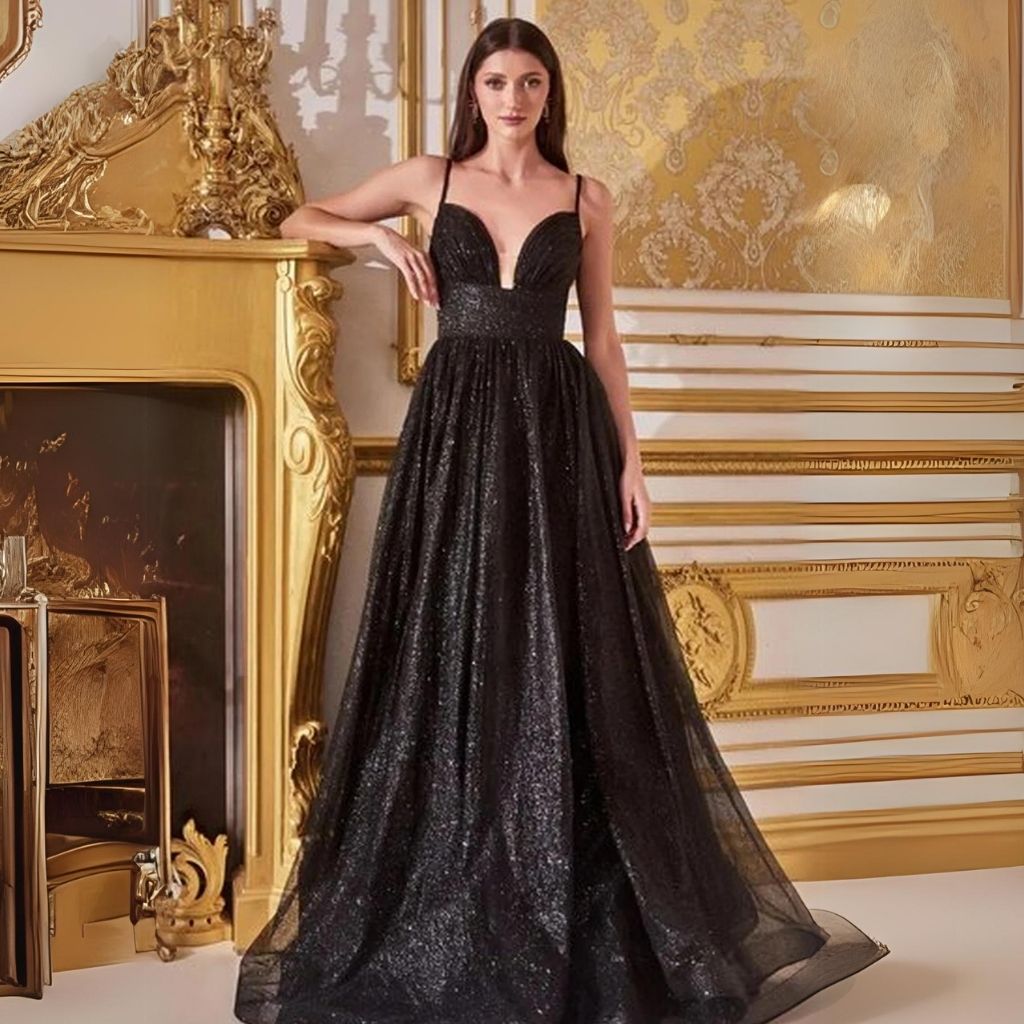 By a golden fireplace, a women wears a black glitter a-line formal dress that flatters apple-shaped figures.