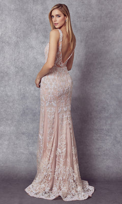 A woman stands facing away, wearing the Glitter-Lace Long Mermaid Formal Dress 277, a floor-length sleeveless gown with a deep V-back, intricate white floral embroidery, and glitter lace over a nude underlay.