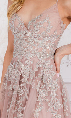 A close-up of a woman wearing the Floral-Embroidered Long A-Line Prom Dress TM1006, featuring blush pink sheer fabric and intricate silver floral embroidery.