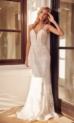 A woman in the Glitter-Lace Long White Prom Dress 277W stands indoors by a glass door, wearing a fitted, sleeveless gown with one hand raised to her head.