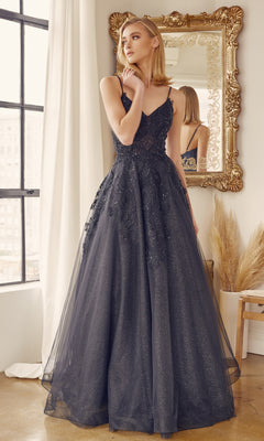 A woman in the Embroidered Glitter-Tulle Long Prom Ball Gown 251 stands indoors near a window and ornate mirror, looking to the side.