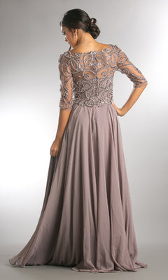 A woman stands with her back to the camera in the Amelia Couture 7046 sleeved long formal dress, featuring a floor-length mauve design with a beaded, semi-sheer bodice and flowing skirt.