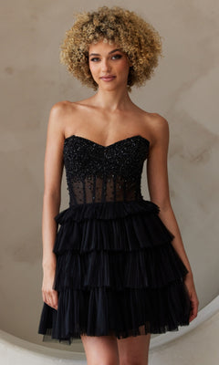 A person poses against a neutral background wearing the Strapless Short Ruffled A-Line Hoco Dress BZ9999S, featuring a beaded bodice and tiered skirt.