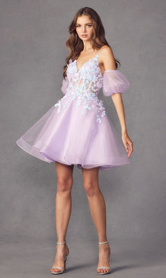A woman poses against a gray background in the Puff-Sleeve Short Butterfly Homecoming Dress 901, a light purple babydoll style with sheer puff sleeves, floral appliqué on the bodice, and clear high-heeled sandals.